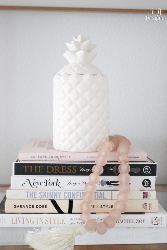 fashion books, fashion coffee table books, style books, blush pink sea glass beads, pineapple ceramic candle, ikea hack shelves, glam style office, decorating with books