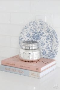 fashion books, fashion coffee table books, style books, blush pink sea glass beads, pineapple ceramic candle, ikea hack shelves, glam style office, decorating with books, styling kitchen with recipe books, blush and blue decor, eat beautiful book, pink and blue decor