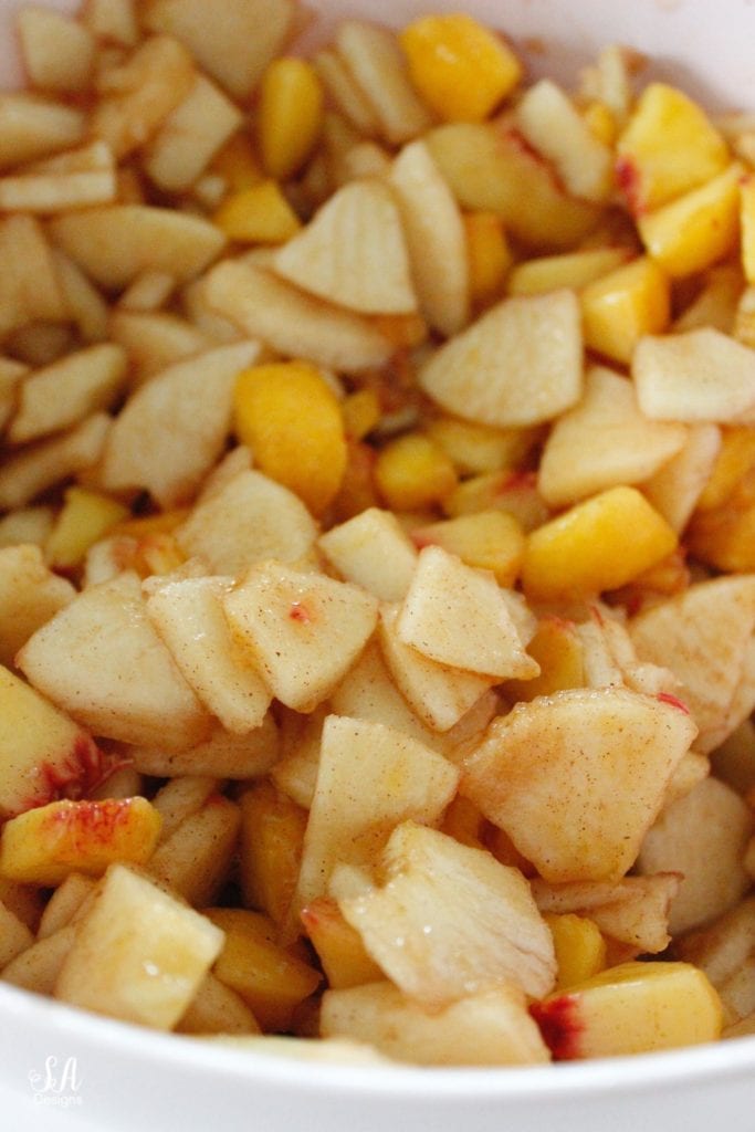 cut up apples and peaches cinnamon and sugar lemon juice