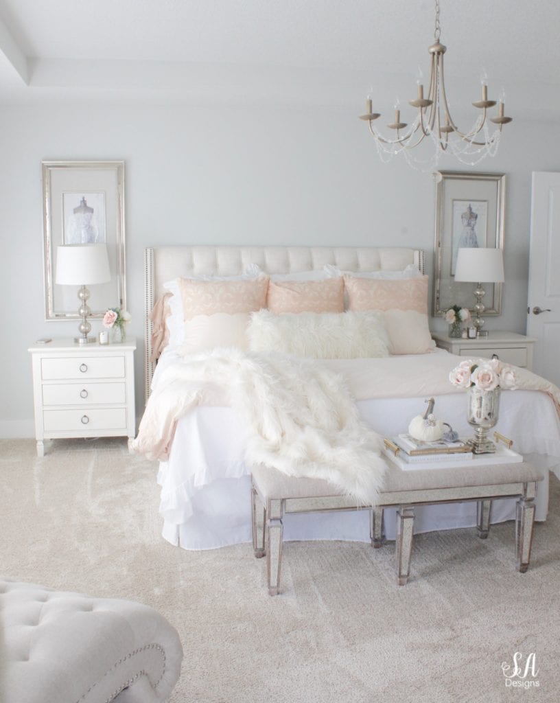 blush pink bedding, pom pom at home, romantic homes, romantic feminine bedroom, faux fur throw blanket, faux fur lumbar oblong pillow, tufted headboard skyline furniture, mirrored bench, chandelier, winter bedding, fall bedding, velvet pumpkins, hotskwash pumpkins, french provincial dresser, french style inspired vanity, agape candles, pink matches, pumpkin candle, fall candle