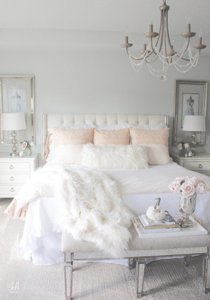 blush pink bedding, pom pom at home, romantic homes, romantic feminine bedroom, faux fur throw blanket, faux fur lumbar oblong pillow, tufted headboard skyline furniture, mirrored bench, chandelier, winter bedding, fall bedding, velvet pumpkins, hotskwash pumpkins, french provincial dresser, french style inspired vanity, agape candles, pink matches, pumpkin candle, fall candle