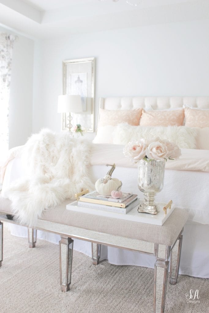 blush pink bedding, pom pom at home, romantic homes, romantic feminine bedroom, faux fur throw blanket, faux fur lumbar oblong pillow, tufted headboard skyline furniture, mirrored bench, chandelier, winter bedding, fall bedding, velvet pumpkins, hotskwash pumpkins, french provincial dresser, french style inspired vanity, agape candles, pink matches, pumpkin candle, fall candle