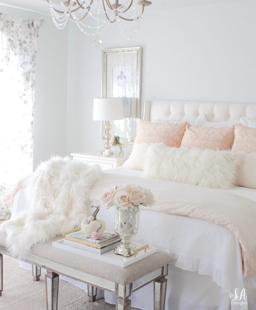 blush pink bedding, pom pom at home, romantic homes, romantic feminine bedroom, faux fur throw blanket, faux fur lumbar oblong pillow, tufted headboard skyline furniture, mirrored bench, chandelier, winter bedding, fall bedding, velvet pumpkins, hotskwash pumpkins, french provincial dresser, french style inspired vanity, agape candles, pink matches, pumpkin candle, fall candle