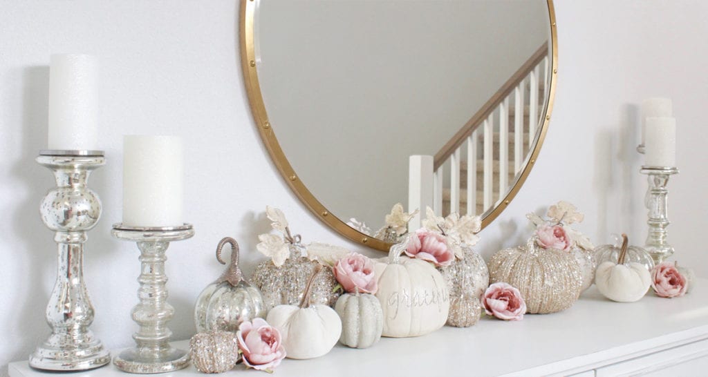 front entry table, white entry table, glitter pumpkins, glam pumpkins, fall pumpkin decor, elegant velvet mercury glass pumpkins, glitter pumpkins decor, round mirror, mercury glass candle holders, caitlin wilson rug jolie collection luna rug, glam fall style, elegant glam fall decor, blue and pink fall decor, blush and blue fall decor