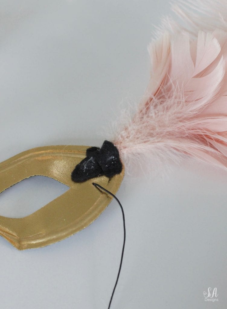 black eye mask, halloween mask, costume mask, blush pink feather joanns, swarovski crystals, diy halloween mask, diy halloween craft, diy mask, glam halloween decor costume, chic halloween decor, elegant halloween decor, blush pink and black masquerade mask