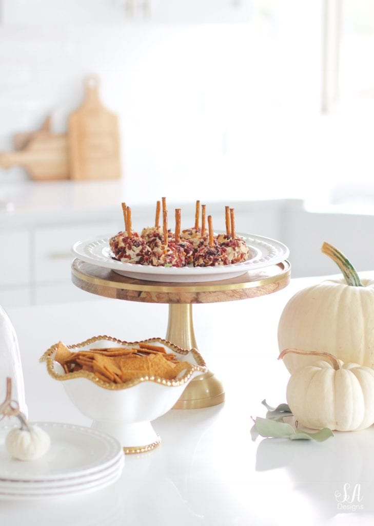 fall recipes, fall appetizers, cheese ball recipe, pink kitchenaid hand mixer, pink kitchenaid mixing bowls, white kitchen, brass pendant lights with crystals, wood and brass cake stand with dome, white dishes, white pumpkins, white interiors