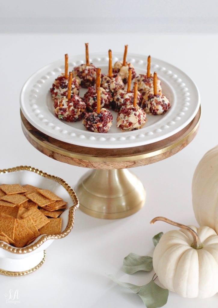 fall recipes, fall appetizers, cheese ball recipe, pink kitchenaid hand mixer, pink kitchenaid mixing bowls, white kitchen, brass pendant lights with crystals, wood and brass cake stand with dome, white dishes, white pumpkins, white interiors