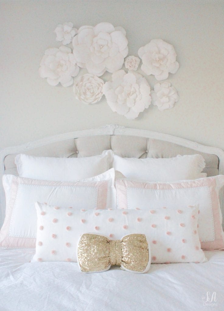 blush bedroom, blush and gold, blush gold grey, modern vintage style, modern vintage bedroom, modern vintage home decor, paper flowers on wall, french provincial furniture nightstands, gold hardware, pottery barn teen pottery barn kids monique lhuillier ethereal sateen duvet shams bedding, pbteen, sparkly crystal chandelier, pbkids chandelier, blush pink satin windows curtains window treatments, vintage gold bow mirror, kate spade ellery ivory bow lamps gold finish, nordstrom at home blush pink pom pom throw blanket, restoration hardware children and baby colette bed, grey tufted modern vintage headboard, white vanity, faux fur vanity stool, girls vanity, girls bedroom ideas, tween teen girls bedroom