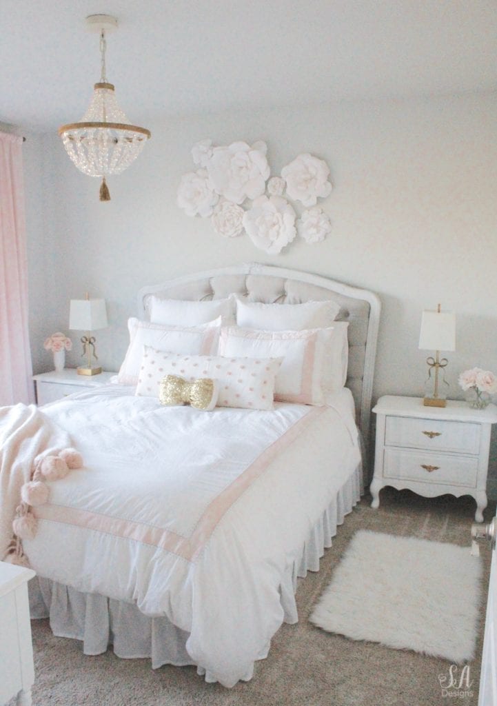 blush bedroom, blush and gold, blush gold grey, modern vintage style, modern vintage bedroom, modern vintage home decor, paper flowers on wall, french provincial furniture nightstands, gold hardware, pottery barn teen pottery barn kids monique lhuillier ethereal sateen duvet shams bedding, pbteen, sparkly crystal chandelier, pbkids chandelier, blush pink satin windows curtains window treatments, vintage gold bow mirror, kate spade ellery ivory bow lamps gold finish, nordstrom at home blush pink pom pom throw blanket, restoration hardware children and baby colette bed, grey tufted modern vintage headboard, white vanity, faux fur vanity stool, girls vanity, girls bedroom ideas, tween teen girls bedroom