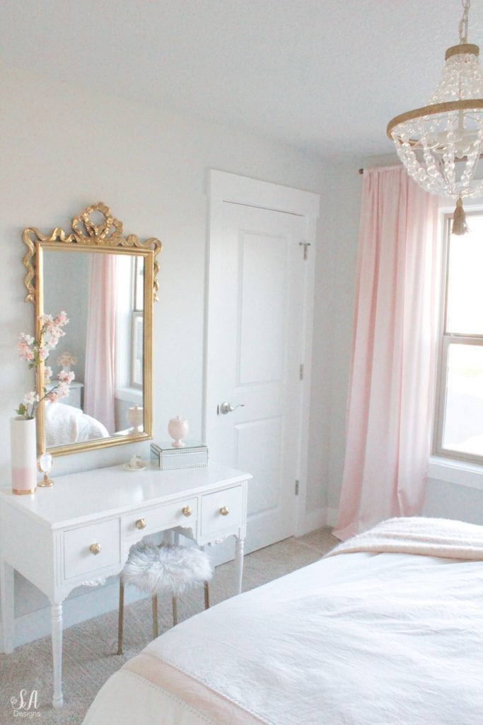 blush bedroom, blush and gold, blush gold grey, modern vintage style, modern vintage bedroom, modern vintage home decor, paper flowers on wall, french provincial furniture nightstands, gold hardware, pottery barn teen pottery barn kids monique lhuillier ethereal sateen duvet shams bedding, pbteen, sparkly crystal chandelier, pbkids chandelier, blush pink satin windows curtains window treatments, vintage gold bow mirror, kate spade ellery ivory bow lamps gold finish, nordstrom at home blush pink pom pom throw blanket, restoration hardware children and baby colette bed, grey tufted modern vintage headboard, white vanity, faux fur vanity stool, girls vanity, girls bedroom ideas, tween teen girls bedroom