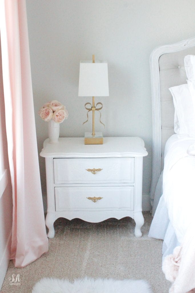 blush bedroom, blush and gold, blush gold grey, modern vintage style, modern vintage bedroom, modern vintage home decor, paper flowers on wall, french provincial furniture nightstands, gold hardware, pottery barn teen pottery barn kids monique lhuillier ethereal sateen duvet shams bedding, pbteen, sparkly crystal chandelier, pbkids chandelier, blush pink satin windows curtains window treatments, vintage gold bow mirror, kate spade ellery ivory bow lamps gold finish, nordstrom at home blush pink pom pom throw blanket, restoration hardware children and baby colette bed, grey tufted modern vintage headboard, white vanity, faux fur vanity stool, girls vanity, girls bedroom ideas, tween teen girls bedroom