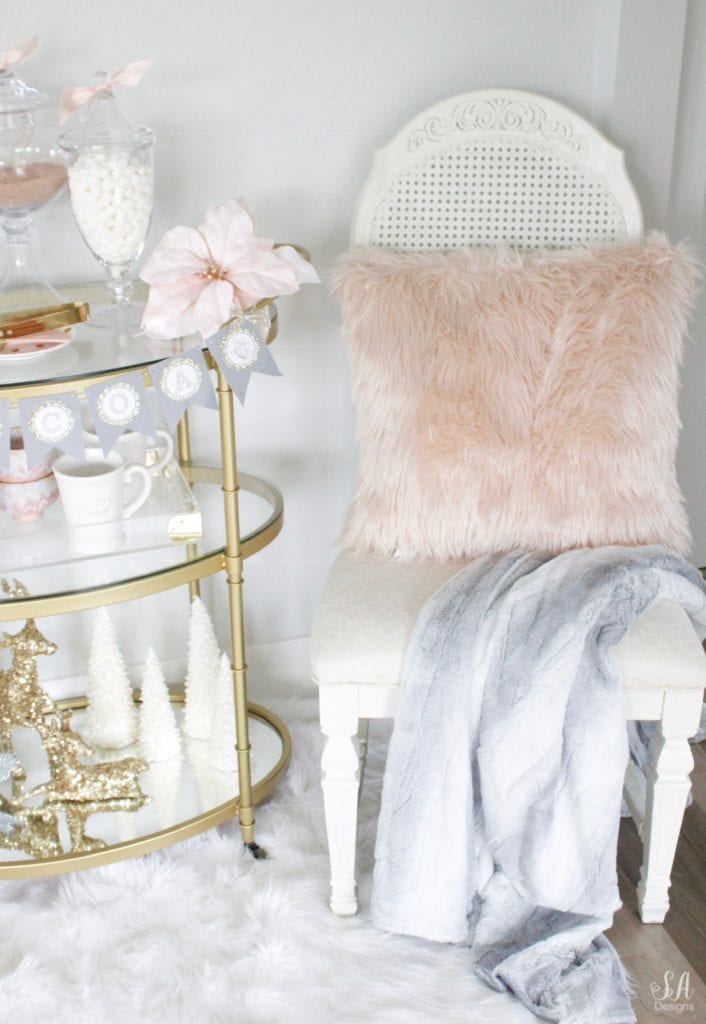 faux fur white rug, faux fur dusty blue throw blankets, blush peach pink faux fur throw pillows, vintage dining chairs white, brass gold bar cart 3 tier, diy hot cocoa station bar cart banner garland, glitter sequin white faux deer head, deer wall decoration, flocked white wreath, gold opalhouse brass wreath, blush and blue christmas, apothecary jars for hot chocolate, gold sequin glitter deer, white glitter christmas tree candles, pier one faux fur mug, acrylic brass tray, anthropologie home blue and pink bowls, white crown mugs, deer head with rhinestone crown, deer with blush satin bow