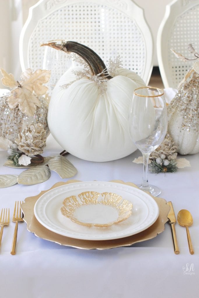 Thanksgiving table, fall table, fall tablescape, white and gold table setting place setting, elegant thanksgiving decor, chic glam thanksgiving decor, zgallerie beaded pumpkins and gourds and leaves, hotskwash velvet pumpkins, white gold champagne ivory tablescape, crystal chandelier, white kitchen design, brass pendant lights, brass hardware, vintage dining set, french inspired style, live in perigold, zgallerie beaded leaves and grape clusters