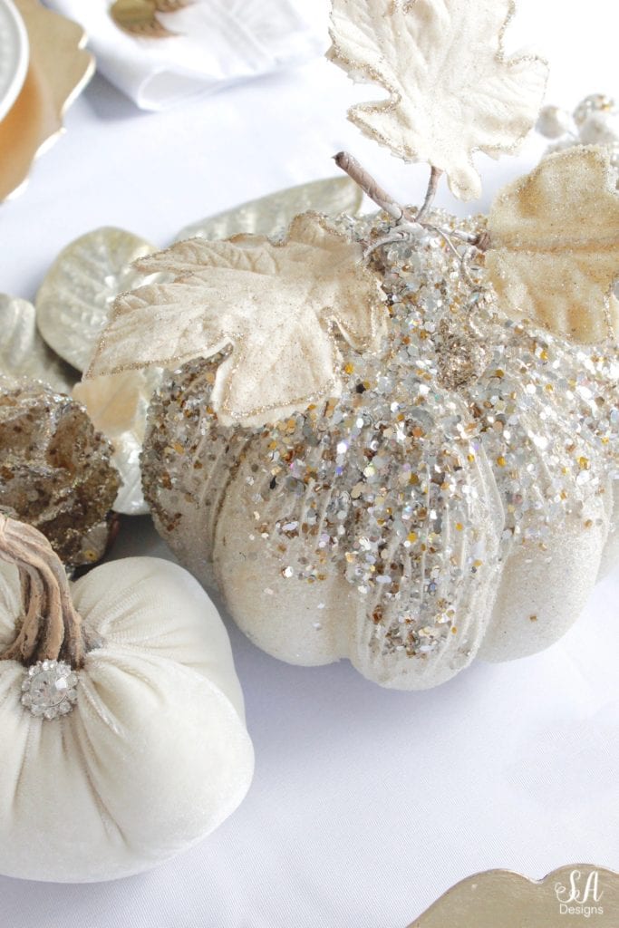 Thanksgiving table, fall table, fall tablescape, white and gold table setting place setting, elegant thanksgiving decor, chic glam thanksgiving decor, zgallerie beaded pumpkins and gourds and leaves, hotskwash velvet pumpkins, white gold champagne ivory tablescape, crystal chandelier, white kitchen design, brass pendant lights, brass hardware, vintage dining set, french inspired style, live in perigold, zgallerie beaded leaves and grape clusters