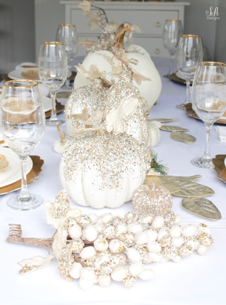 Thanksgiving table, fall table, fall tablescape, white and gold table setting place setting, elegant thanksgiving decor, chic glam thanksgiving decor, zgallerie beaded pumpkins and gourds and leaves, hotskwash velvet pumpkins, white gold champagne ivory tablescape, crystal chandelier, white kitchen design, brass pendant lights, brass hardware, vintage dining set, french inspired style, live in perigold, zgallerie beaded leaves and grape clusters