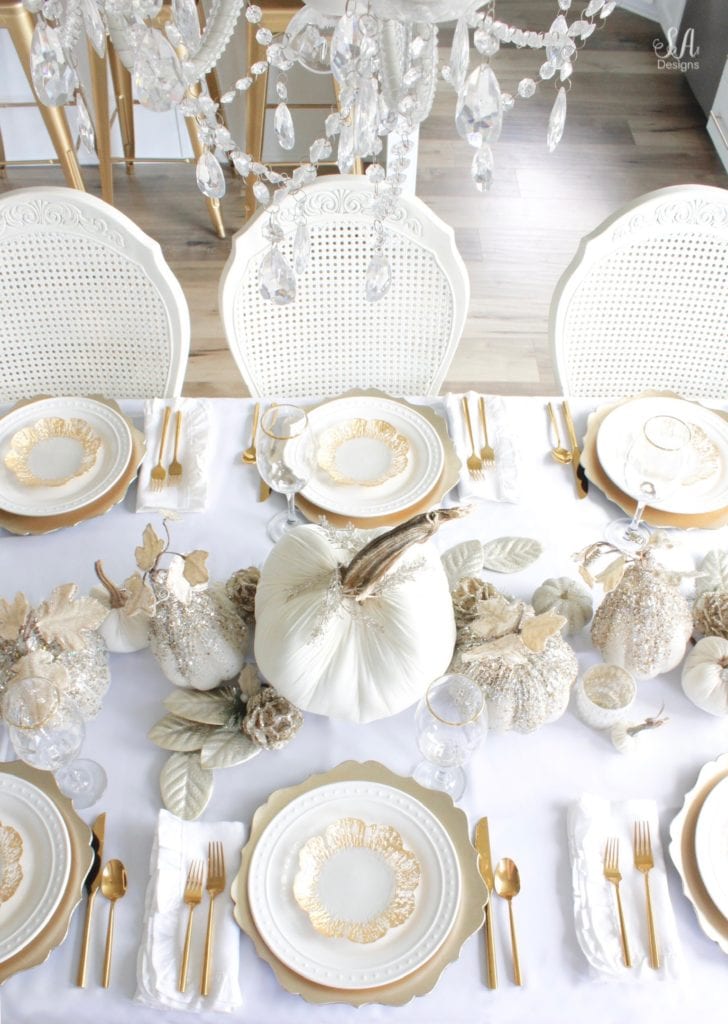 Thanksgiving table, fall table, fall tablescape, white and gold table setting place setting, elegant thanksgiving decor, chic glam thanksgiving decor, zgallerie beaded pumpkins and gourds and leaves, hotskwash velvet pumpkins, white gold champagne ivory tablescape, crystal chandelier, white kitchen design, brass pendant lights, brass hardware, vintage dining set, french inspired style, live in perigold, zgallerie beaded leaves and grape clusters