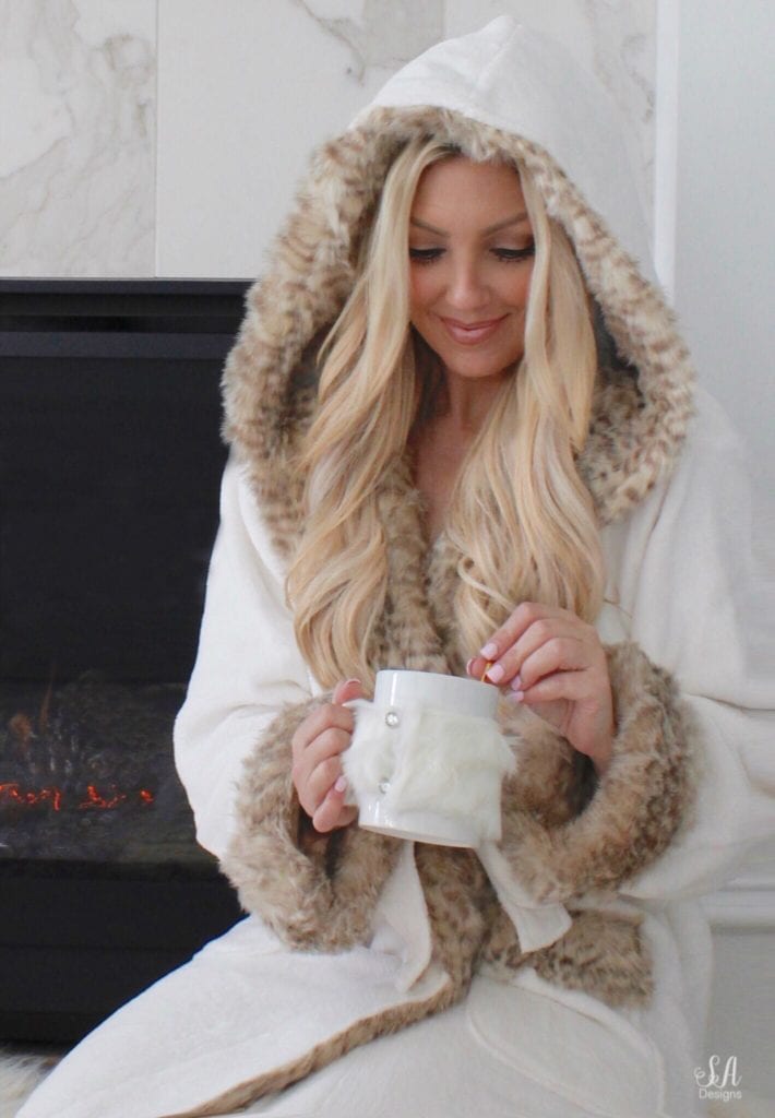 pottery barn faux fur robe dune leopard, pottery barn faux fur slippers, leopard print robe, pottery barn pottery barn teen faux fur ivory throw blanket, white interiors, interior blogger, blonde hair, blogger hair, tea in front of fire, cuddling by the fire, white marble tile fireplace mantel hearth, pottery barn candles tuberose