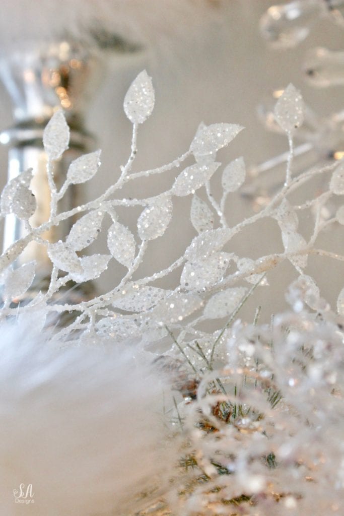 dreamy whimsical fantasy playful christmas mantel, faux fur stockings with snowflakes, christmas flocked garland with jewel rhinestone gold glitter pearl jewels garland, blush feather, faux fur pom poms, white glitter berry christmas stems, sparkly glitter christmas magnolia stems, dusty blue velvet ribbon, glitter snowflakes, joann fabric white swan figures, mercury glass candlesticks, cozy glam winter wonderland christmas, white fireplace marble tile, christmas glitter stems and picks