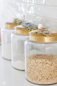 brass kitchen canister with ribbon and christmas stem