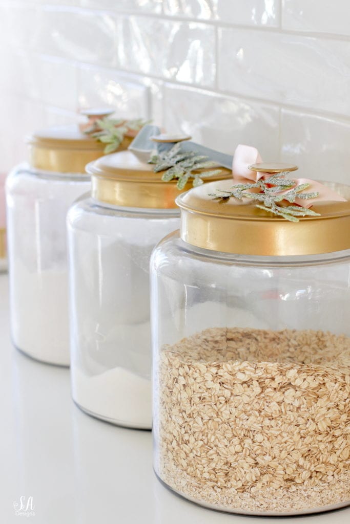 brass kitchen canister with ribbon and christmas stem