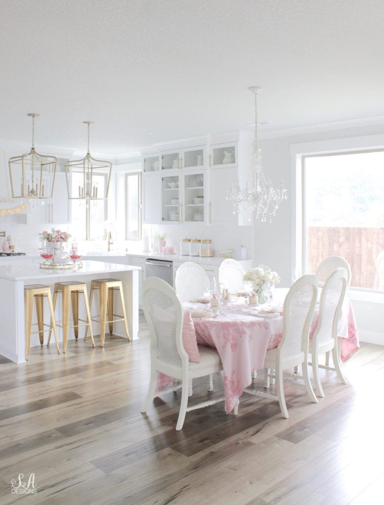 monique lhuillier pottery barn, pink floral tablecloth, pink floral plates, white kitchen design, vintage valentines day tablescape, valentines decor table