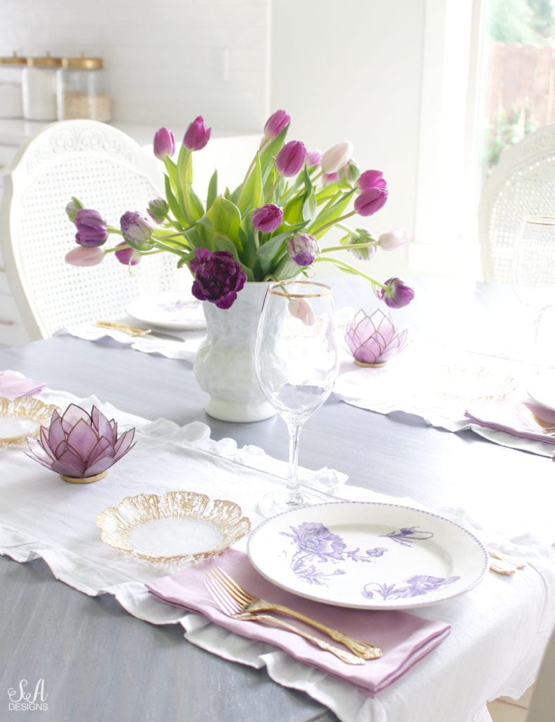 summer tablescape, spring tablescape, purple tablescape, purple tulips arrangement, purple lavender tulips, purple double peony tulips, double tulip peonies, antique french lavender transferware plates, paris france flea market find, gold flatware, purple orchid dinner napkins world market, gold rimmed crystal goblets, purple petal lotus capiz tea light holder world market, white ruffle linen table runners, crystorama clear crystal chandelier, anthropologie mauve lavender blouse top, white kitchen design, pacific northwest interior designer blogger fashion blogger summer adams designs, white milkglass vase