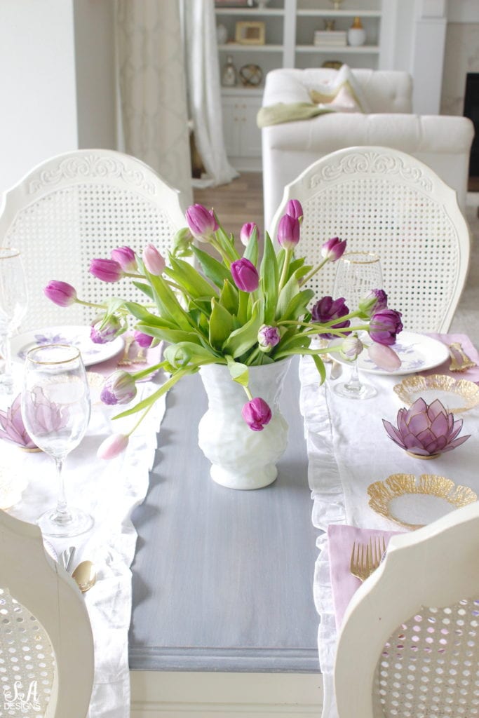 summer tablescape, spring tablescape, purple tablescape, purple tulips arrangement, purple lavender tulips, purple double peony tulips, double tulip peonies, antique french lavender transferware plates, paris france flea market find, gold flatware, purple orchid dinner napkins world market, gold rimmed crystal goblets, purple petal lotus capiz tea light holder world market, white ruffle linen table runners, crystorama clear crystal chandelier, anthropologie mauve lavender blouse top, white kitchen design, pacific northwest interior designer blogger fashion blogger summer adams designs, white milkglass vase