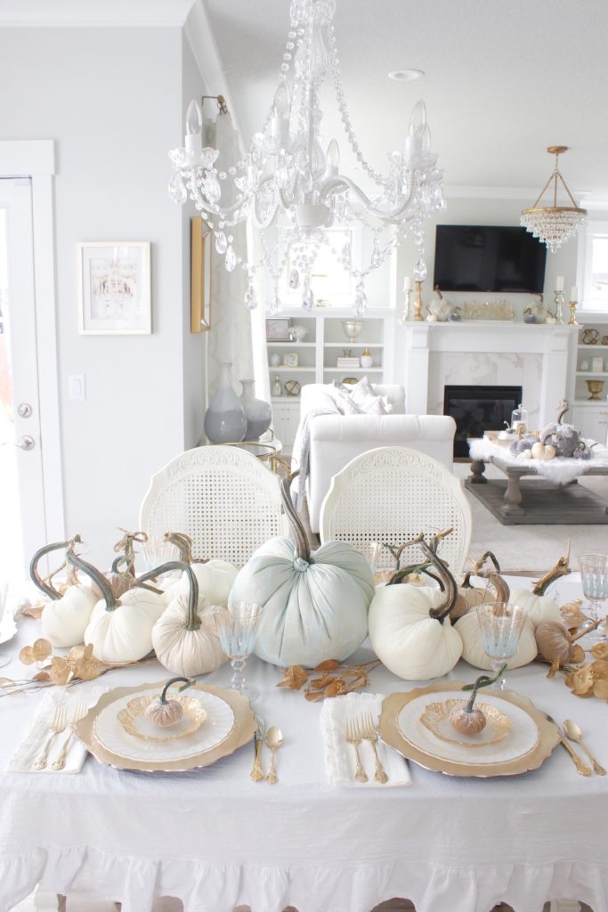 classy fall table, glam fall table, glam fall tablescape, elegant fall tablescape, white and gold fall table, gilded fall table, spa blue fall table, hot skwash velvet pumpkins, patina vie Aquarius goblets, ruffled tablecloth, ruffled ivory dinner napkins, gold flatware, gold-rimmed plates, gold flower butter plate dessert plates, vintage milk glass plates gold rim, gold chargers, pier1 gold eucalyptus stems, pier1 gold money glitter stems, white and gold fall kitchen decor, white velvet pumpkins, bellacor minka lavery pendants, white kitchen design, velvet pumpkins with Swarovski crystals, French country dining set, coastal kitchen, transitional kitchen, contemporary white elegant kitchen