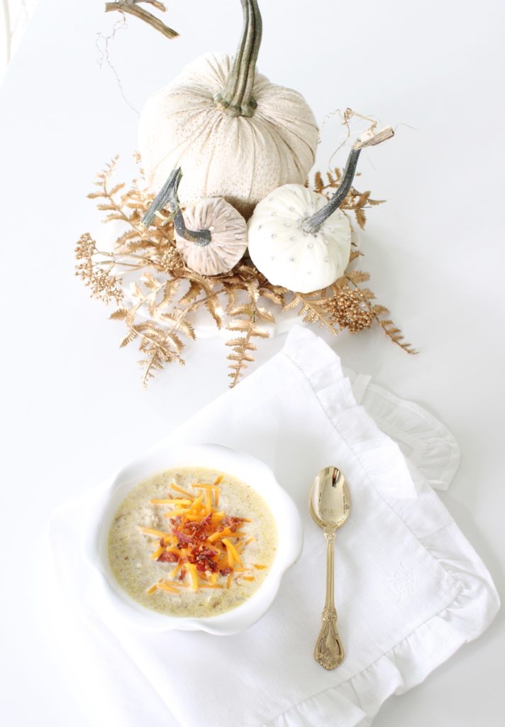 keto soup recipes, keto fall recipes, low-carb soup recipes, Atkins soup recipes, Keto cauliflower, Atkins cauliflower, low-carb cauliflower, cauliflower and cheese soup, creamy cauliflower soup, white and gold, white ruffle linen napkin, gold spoon, white and gold beaded bowls, loaded cauliflower soup, white and gold velvet pumpkins, elegant fall decor, white and brass kitchen