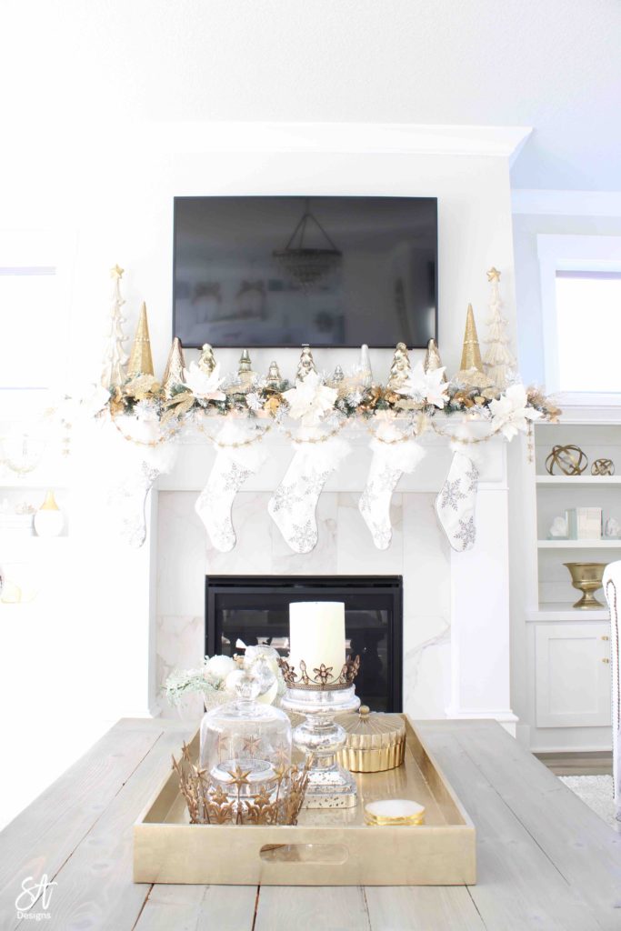 white and gold elegant glam Christmas decor, Christmas coffee table, ornaments in ZGallerie beaded pedestal bowl with ribbon, terrain Anthropologie Santos crowns, crowns on candlesticks, mercury glass candlesticks, Christmas coffee table