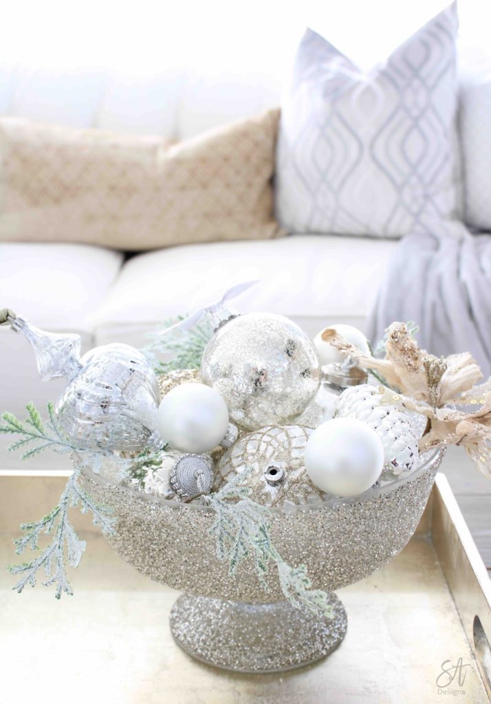 white and gold elegant glam Christmas decor, Christmas coffee table, ornaments in ZGallerie beaded pedestal bowl with ribbon, terrain Anthropologie Santos crowns, crowns on candlesticks, mercury glass candlesticks, Christmas coffee table