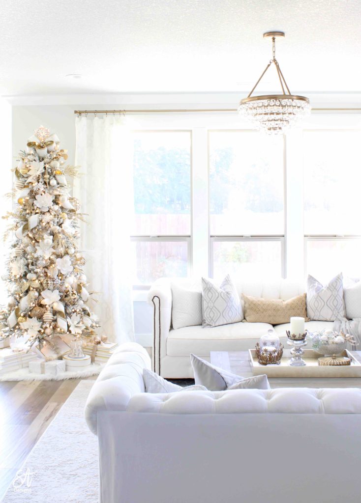 white and gold elegant glam Christmas decor, Christmas coffee table, ornaments in ZGallerie beaded pedestal bowl with ribbon, terrain Anthropologie Santos crowns, crowns on candlesticks, mercury glass candlesticks, Christmas coffee table, crystorama calypso chandelier