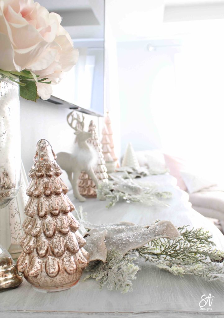 white Christmas tree, pink poinsettia Christmas ornaments, vintage pink glass ornaments, crown Christmas tree topper, romantic Christmas bedroom, blush pink mercury glass trees, glitter reindeer, blue pink velvet quilted bedding, blush pink fringe ottoman, pottery barn jewelry storage, Christmas bedroom decor ideas, master bedroom Christmas decorating ideas