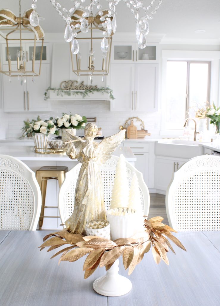 angel centerpiece for Christmas, gold wreath on white cake stand, white and gold Christmas kitchen decor