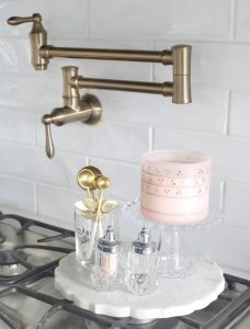 pink cookbooks, pink heart-shaped baking dishes, diptyque candles with flowers, pink macarons,Voluspa candles, Voluspa 123 oz rose candle, valentines diy fresh flowers arrangement at home, classy Valentine's Day decor, elegant Valentine's decor, soft romantic pink Valentine's Day decor, glam Valentine's decorations, classy elegant glam Valentine's pennant banner garland, Valentine's flower arrangements, pink ginger jars, Valentine's candy bar buffet, Valentine's cocoa hot chocolate bar, Valentine's bar cart, Valentine's living room decor, Valentine's entry way decor, classy glam elegant Valentine's Day decorating ideas, white kitchen decorated for Valentine's Day, elegant Valentine's tablescapes, gold mirrored tray, gold sequin heart banner, mercury glass votives pottery barn, ruffle cake stand, voluspa macaron candles, milk glass pedestal bowls