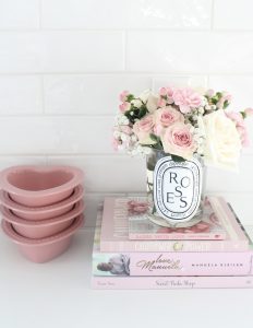 pink cookbooks, pink heart-shaped baking dishes, diptyque candles with flowers, pink macarons,Voluspa candles, Voluspa 123 oz rose candle, valentines diy fresh flowers arrangement at home, classy Valentine's Day decor, elegant Valentine's decor, soft romantic pink Valentine's Day decor, glam Valentine's decorations, classy elegant glam Valentine's pennant banner garland, Valentine's flower arrangements, pink ginger jars, Valentine's candy bar buffet, Valentine's cocoa hot chocolate bar, Valentine's bar cart, Valentine's living room decor, Valentine's entry way decor, classy glam elegant Valentine's Day decorating ideas, white kitchen decorated for Valentine's Day, elegant Valentine's tablescapes, gold mirrored tray, gold sequin heart banner, mercury glass votives pottery barn, ruffle cake stand, voluspa macaron candles, milk glass pedestal bowls