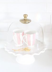 pink and blue spring kitchen decor, white kitchen design, white and gold kitchen, voluspa large 5 wick candle, voluspa macaron candles, white hood, white and gold kitchen, kitchen goals, Caitlin Wilson blue bread cutting board French blue, blogger kitchen inspiration