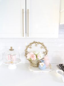 pink and blue spring kitchen decor, white kitchen design, white and gold kitchen, voluspa large 5 wick candle, voluspa macaron candles, white hood, white and gold kitchen, kitchen goals, Caitlin Wilson blue bread cutting board French blue, blogger kitchen inspiration