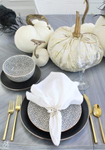 walmart dinnerware, affordable dinnerware, glam modern dinnerware, modern place settings, velvet pumpkins, black and white halloween table, white cloth dinner napkin, gold jewel spider napkin ring, halloween napkin rings, gold flatware, clear goblets gold rimmed
