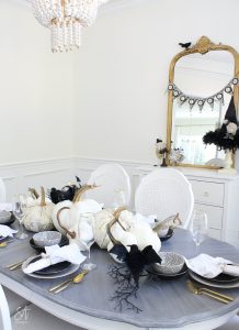 walmart dinnerware, affordable dinnerware, glam modern dinnerware, modern place settings, velvet pumpkins, black and white halloween table, white cloth dinner napkin, gold jewel spider napkin ring, halloween napkin rings, gold flatware, clear goblets gold rimmed