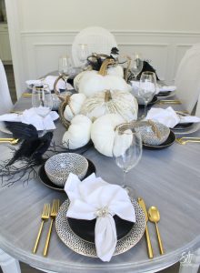 walmart dinnerware, affordable dinnerware, glam modern dinnerware, modern place settings, velvet pumpkins, black and white halloween table, white cloth dinner napkin, gold jewel spider napkin ring, halloween napkin rings, gold flatware, clear goblets gold rimmed