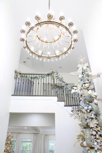 astoria grand lipscomb 24-light candle style tiered chandelier with crystal accents, gold brass large chandelier for entry, gold round chandelier, how to hang garland on staircase banister