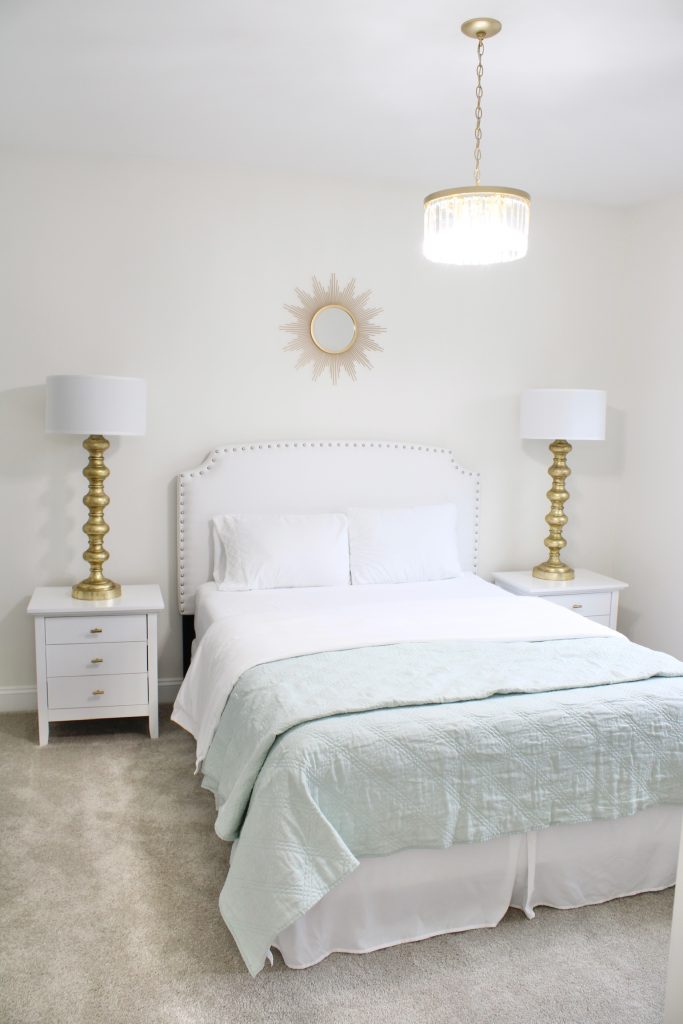 gold sunburst wall mirror, large gold lamps, serene spa blue guest bedroom, walmart home, white nightstands, white modern headboard, spa blue quilt bedding
