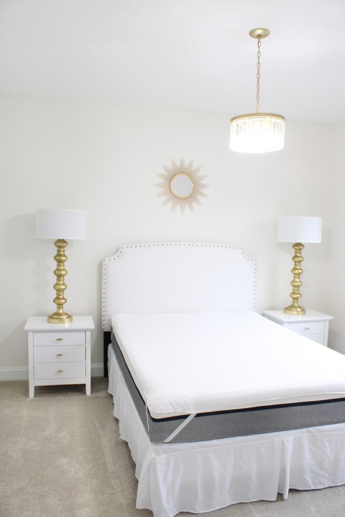 gold starburst wall mirror, large gold lamps, serene spa blue guest bedroom, walmart home, white nightstands, white headboard, spa blue quilt bedding