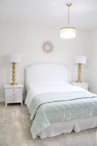 gold sunburst wall mirror, large gold lamps, serene spa blue guest bedroom, walmart home, white nightstands, white modern headboard, spa blue quilt bedding