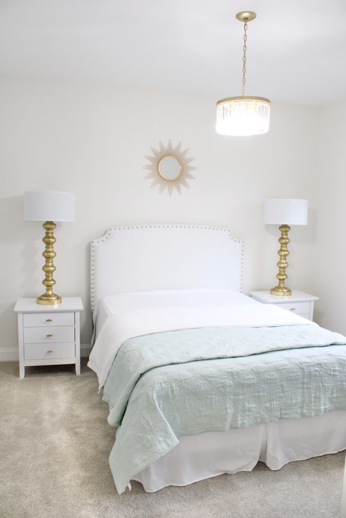 gold sunburst wall mirror, large gold lamps, serene spa blue guest bedroom, walmart home, white nightstands, white modern headboard, spa blue quilt bedding