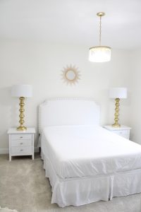 gold sunburst wall mirror, large gold lamps, serene spa blue guest bedroom, walmart home, white nightstands, white modern headboard, spa blue quilt bedding
