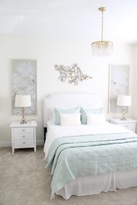 gold sunburst wall mirror, large gold lamps, serene spa blue guest bedroom, walmart home, white nightstands, white modern headboard, spa blue quilt bedding