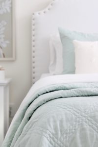 gold sunburst wall mirror, large gold lamps, serene spa blue guest bedroom, walmart home, white nightstands, white modern headboard, spa blue quilt bedding