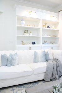 white and gold decor, glam christmas, white walls, ginger jars, classy christmas, christmas blogger tour, white sofas, custom pillow covers, flocked christmas tree, flocked garland christmas mantel